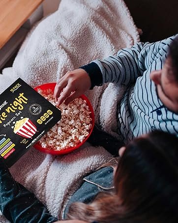 Couple eating popcorn and watching movie